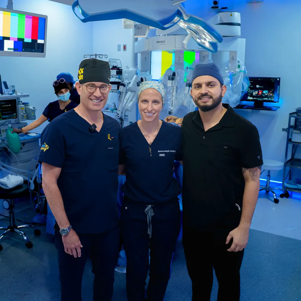 Dr. Jorge Bravo con profesionales de cirugía en un quirófano con sistema robótico